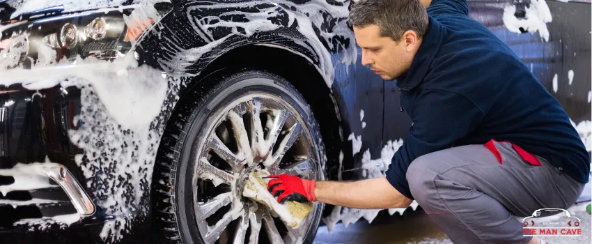 TMC - A man washing a car's tire