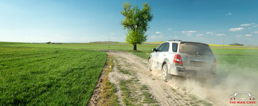 TMC - Car driving through a dusty road