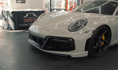 the front end of a porche 911 with ceramic coating applied to it at Man Cave Colorado