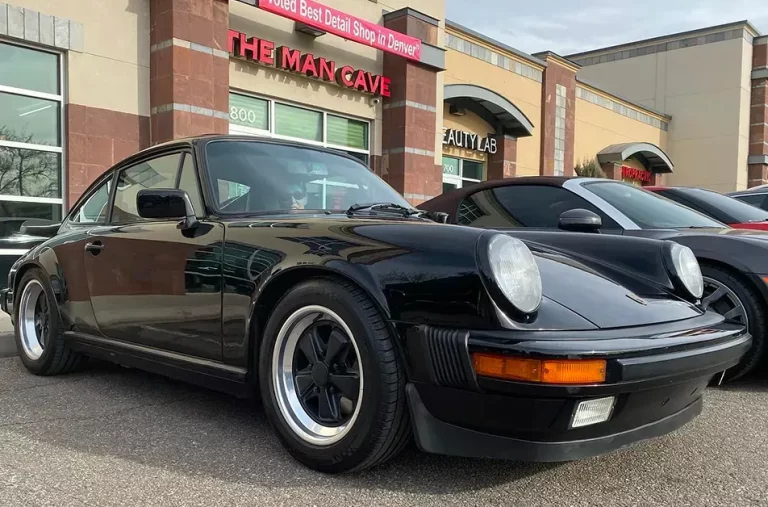 a porche 911 after a detailing in front of Man Cave Colorado